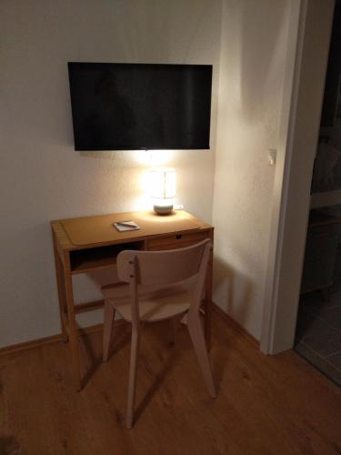 a desk with a lamp and a chair in a room at Klein & Fein - small & beautiful in Handthal