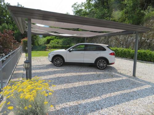 a white car parked under a canopy in a driveway at Ficano's Dream in San Siro