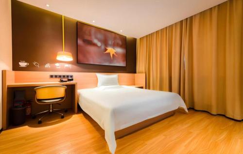 a bedroom with a white bed and a desk and a chair at IU Hotel Kunming Jinma Bijifang Joy City in Kunming