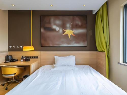 a bedroom with a bed and a desk and a star at IU Hotel Kunming Jinma Bijifang Joy City in Kunming