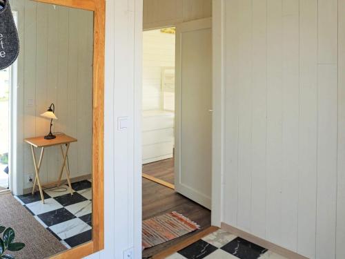 a hallway with a mirror and a table in a room at 5 person holiday home in SÖLVESBORG-By Traum in Sölvesborg