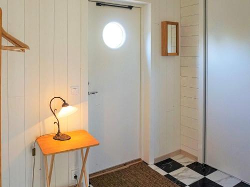 a lamp on a table next to a door at 5 person holiday home in SÖLVESBORG-By Traum in Sölvesborg