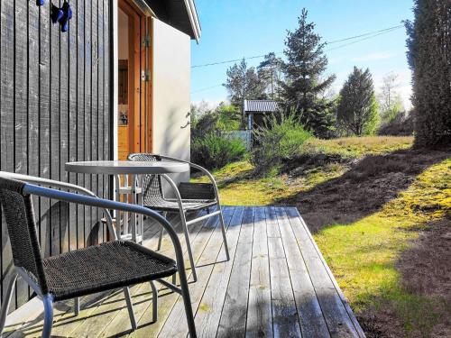 a patio with two chairs and a table on a deck at 6 person holiday home in HENÅN in Henån