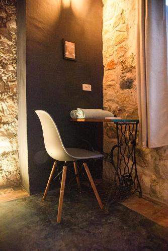 a table and a chair in a room at Habitación frente al mar y alberca in Lerma