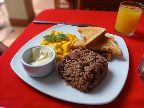 une assiette de nourriture pour le petit-déjeuner sur une table rouge dans l'établissement Hotel El Internacional, à Granada
