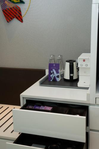 a white counter with a coffee maker on it at Cinnamon Life at City of Dreams in Colombo
