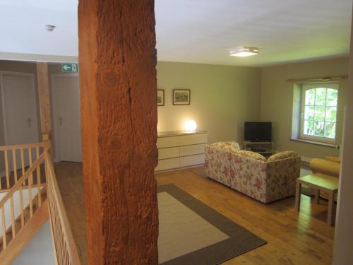 a living room with a couch and a television at Spacious Family Villa, Offagne in Offagne