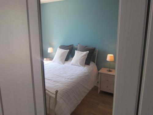 a bedroom with a bed with white sheets and pillows at Spacious Family Villa, Offagne in Offagne