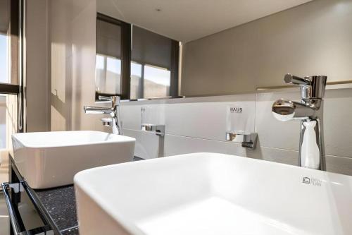 a bathroom with a white sink and a mirror at Hotel Haus in Gapyeong