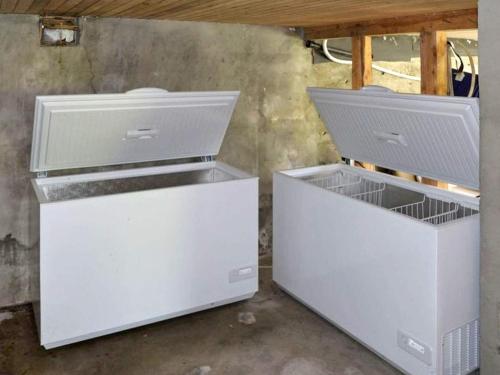 two white drawers sitting next to each other in a room at 10 person holiday home in Stordal in Stordal