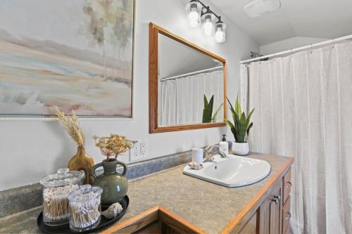 a bathroom with a sink and a mirror at Sky & Stream Escape, EAA AirVenture Oasis in Oshkosh