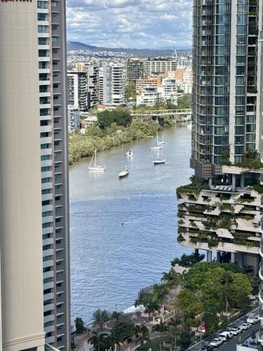 a view of a river between two tall buildings at Indigescapes River Views Brisbane Sleeps 6 Includes Carpark in Brisbane