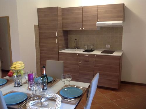 a kitchen with a table with blue plates on it at La Perla in Monte Isola