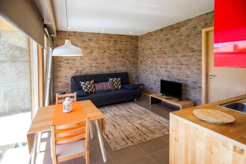 a living room with a couch and a table at Garden House in Porto