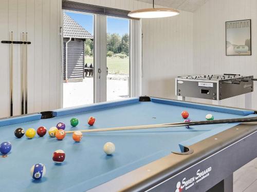 a pool table with balls on it in a room at 5 star holiday home in Stege in Stege