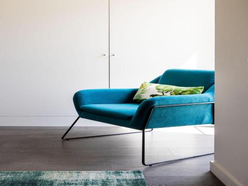 a blue couch sitting in a living room at Luxury Villa in Sint-Idesbald with Jacuzzi in Sint-Idesbald
