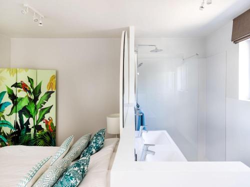 a bedroom with a sink and a bed with pillows at Luxury Villa in Sint-Idesbald with Jacuzzi in Sint-Idesbald