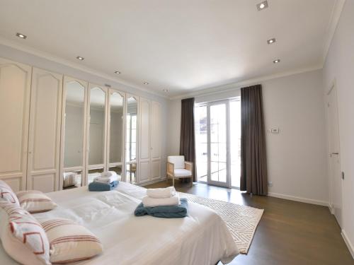 a large white bedroom with a large white bed at Luxury Villa in Sint-Idesbald with Jacuzzi in Sint-Idesbald