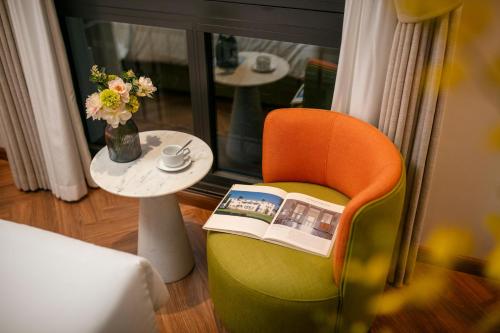 a room with a chair and a table with a book at Léman Old Quarter in Hanoi