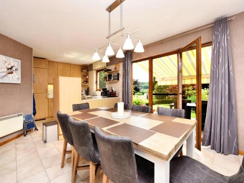 a kitchen and dining room with a table and chairs at Beautiful Holiday Home in Durbuy with Garden in Septon