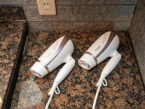 two white game controllers sitting on the floor at East Nagoya Entire 3-Story House in Nagoya