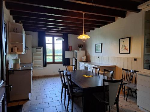 a kitchen with a table and chairs in a room at Comfortable holiday home with spacious garden in Ygrande