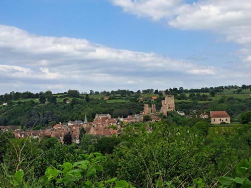 a town in the middle of a field with trees at Comfortable holiday home with spacious garden in Ygrande