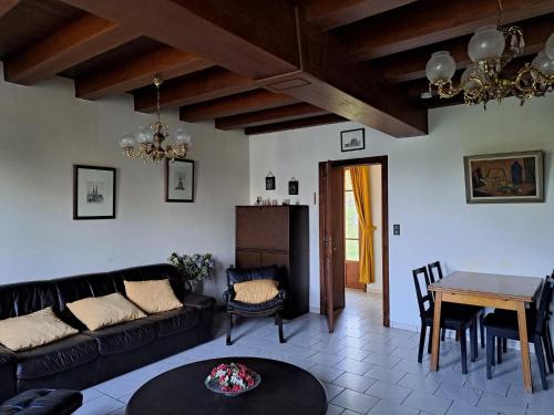 a living room with a couch and a table at Comfortable holiday home with spacious garden in Ygrande