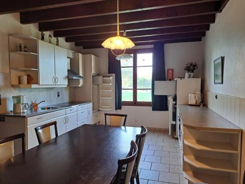 a kitchen with a large wooden table in a room at Comfortable holiday home with spacious garden in Ygrande