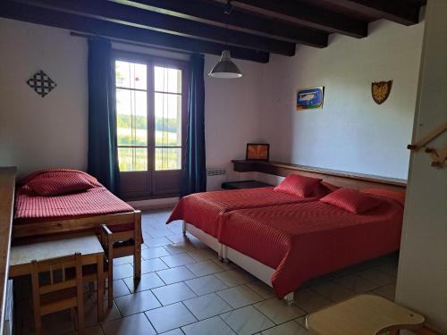 a bedroom with two beds and a window at Comfortable holiday home with spacious garden in Ygrande