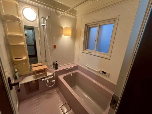 a large bathroom with a tub and a window at komorebi - Vacation STAY 19085 in Hakodate