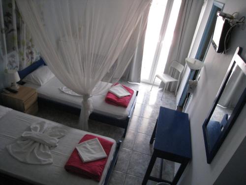 a bedroom with two beds and a window at Cavo Christo in Petra
