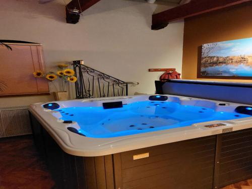 a large blue bath tub in a bathroom at Countryside Villa with Games in Rekken