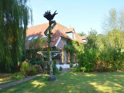 a statue of a woman in front of a house at Countryside Villa with Games in Rekken