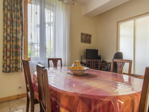 a dining room table with a bowl of fruit on it at Cottage in an old remote farmhouse in Giroux