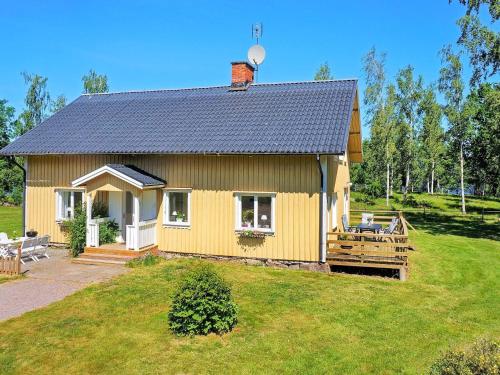 a small yellow house on a grassy field at 14 person holiday home in HOVA-By Traum in Hova
