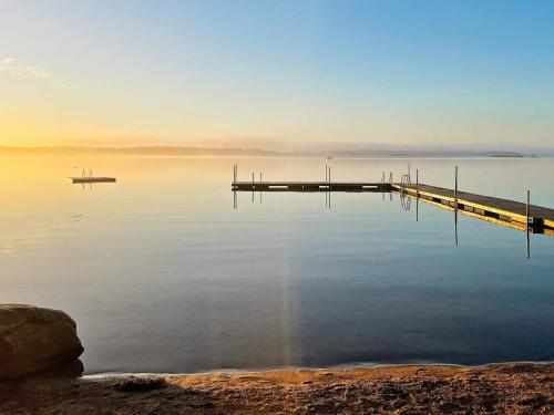 een dok in het midden van een waterlichaam bij Idyllic Family Retreat Close to the Sea in Ronneby