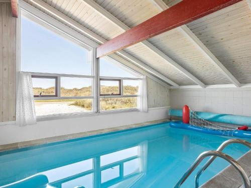 a swimming pool in a house with a window at 4 star holiday home in Hjørring in Kærsgård Strand