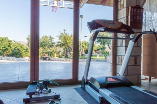 a treadmill in a gym next to a window at Luxury Villa Karteros in Karteros