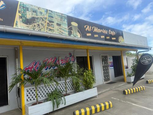 a building with plants in the front of it at Lonely Hill Apartment in Honiara