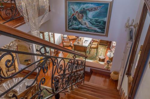 a staircase in a home with a painting on the wall at Luxury Villa Karteros in Karteros