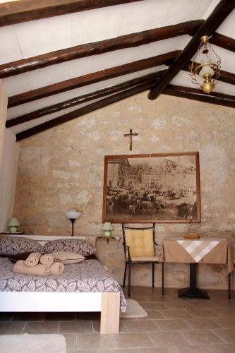 a bedroom with a bed and a cross on the wall at Apartments Garden in Rovinj