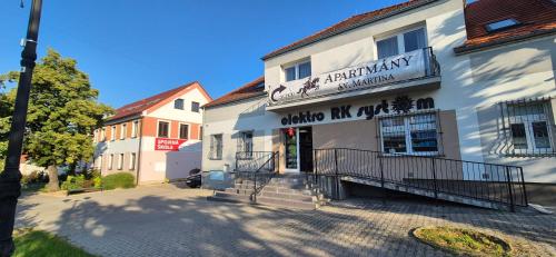 a white building with a sign for a pharmacy at apartmány Svätého Martina in Holíč