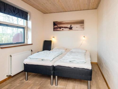 a bed in a small room with a window at 12 person holiday home in Hojslev-By Traum in Bøstrup