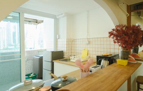 a kitchen with a table and a counter top at Big unit for 8 people, city center Silom in Bangkok