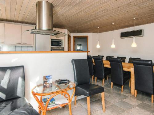 a dining room with a table and black chairs at 12 person holiday home in Hojslev-By Traum in Bøstrup