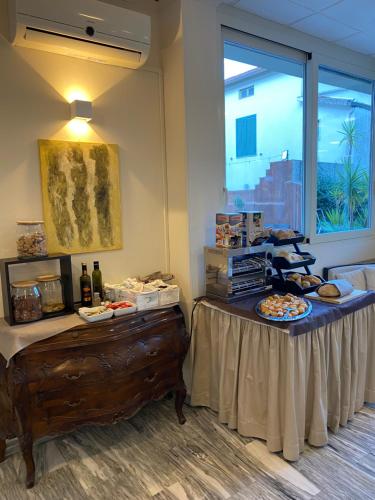 a table with food and bottles of wine on it at Hotel Monti in Lamporecchio