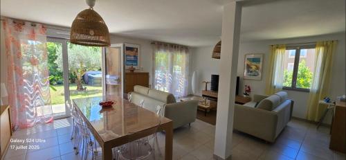 a kitchen and living room with a table and chairs at New house with all comforts in Grimaud in Grimaud