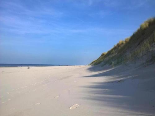 a sandy beach with footprints in the sand at Cottage in Nes-Ameland near Coastline in Nes