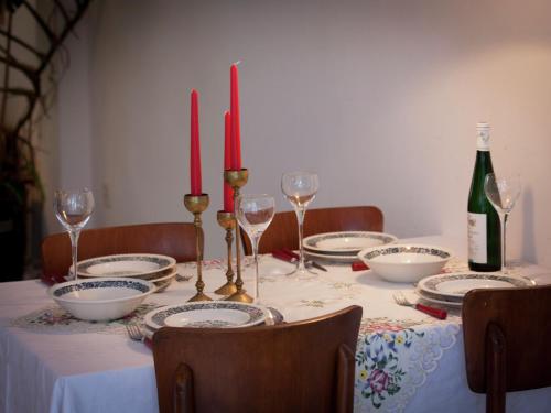 a table with plates and glasses and a bottle of wine at Cottage in Nes-Ameland near Coastline in Nes